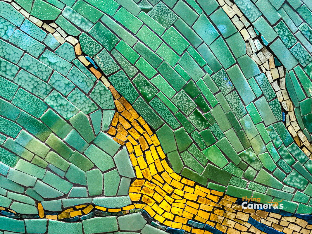 Mural tile design with shades of green and yellow tiles