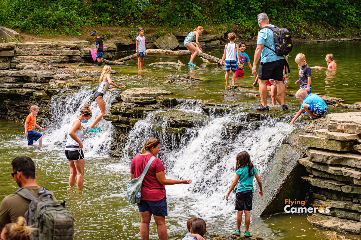 Families enjoying water on a summer afternoon in Waterfall Glen